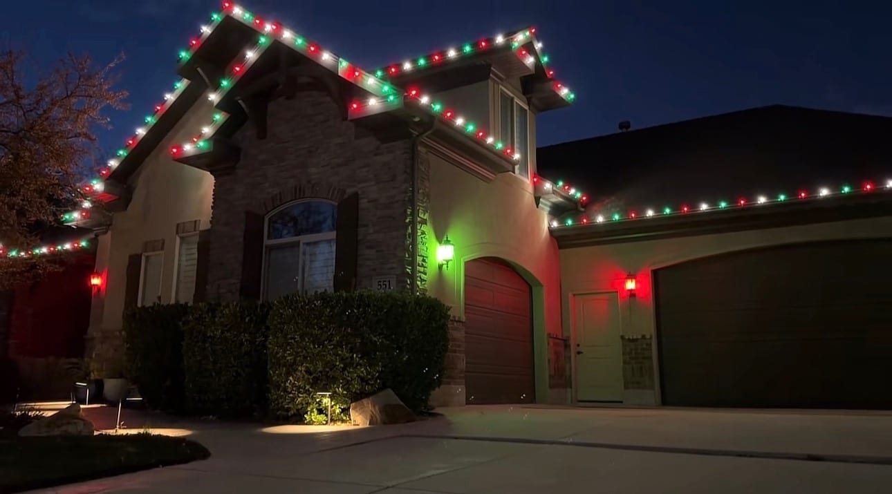 Holiday lights fitted along a home’s roof and garage trim