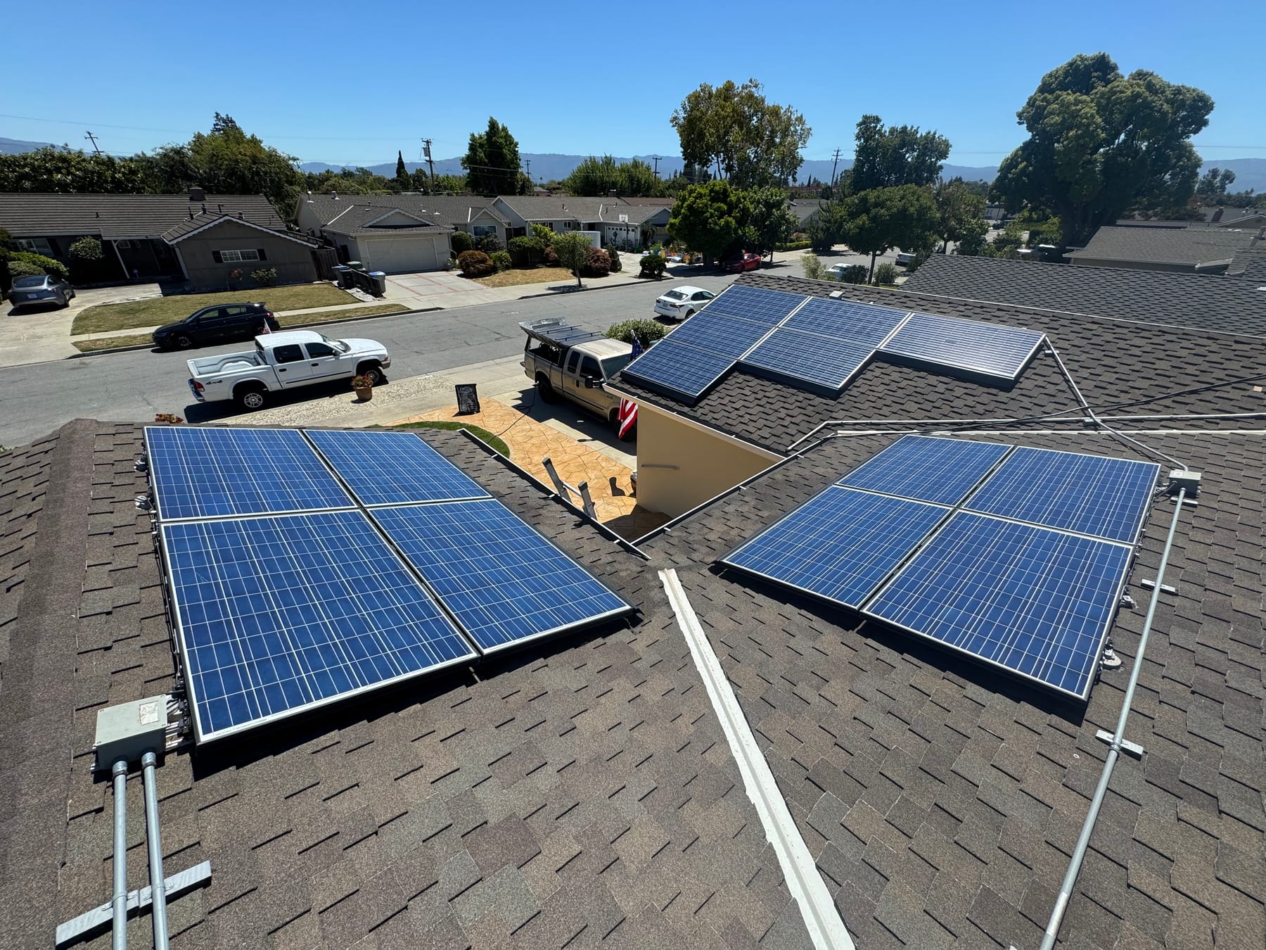 Clean solar panels across a shingle roof