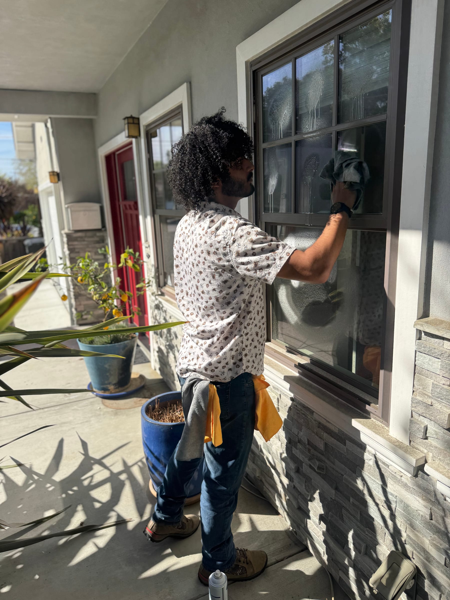 Bright Blast Teens cleaning an exterior window with a squeegee