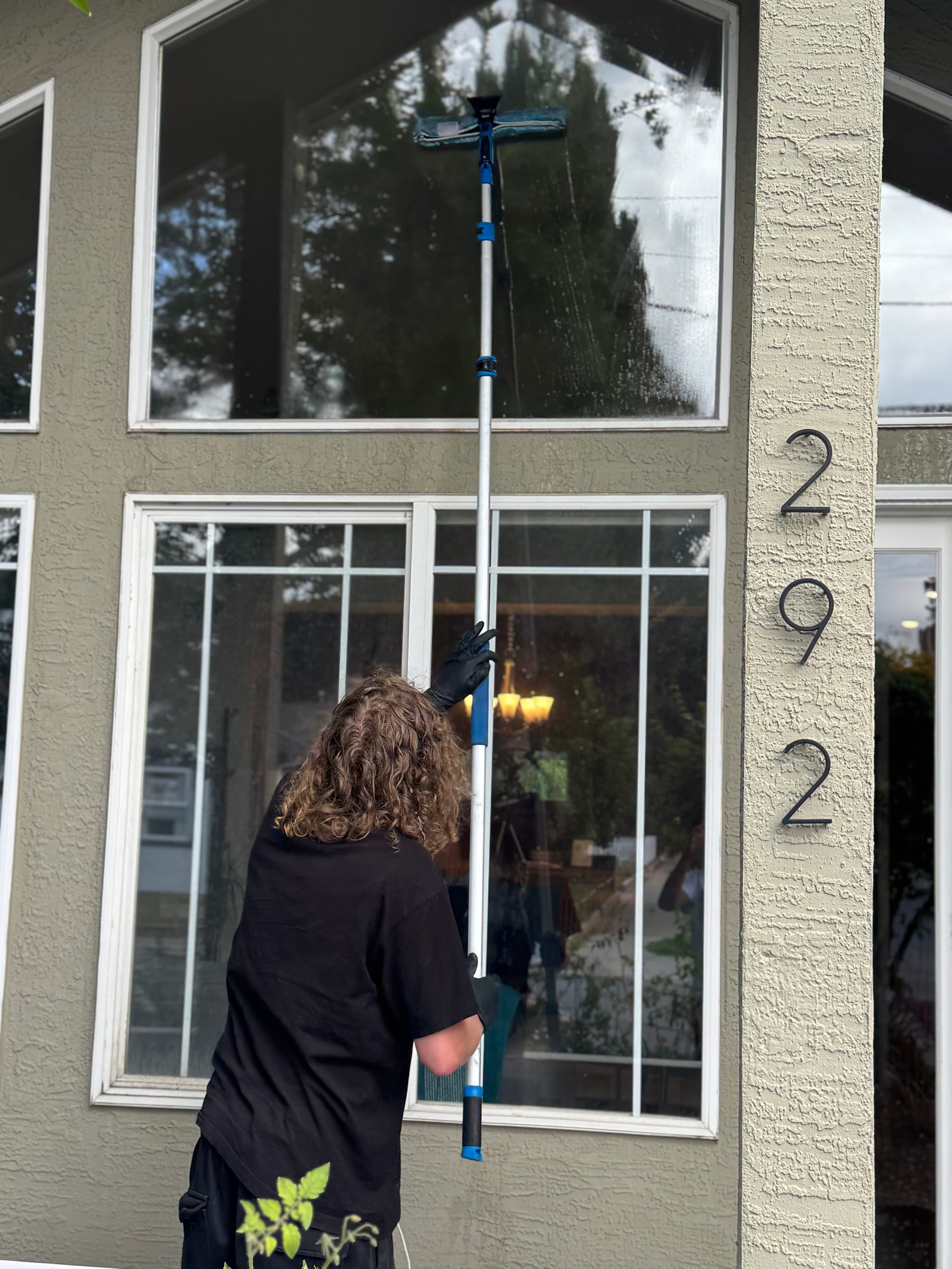 Window cleaning with a water-fed pole on tall residential windows